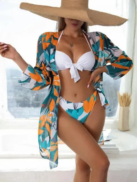 Women's three-piece bikini swimsuit set with mesh split detail and a cover-up coat.