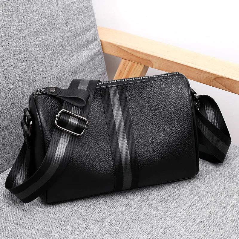 Black genuine leather crossbody bag with dimensions 24cm wide by 16cm high by 13cm deep