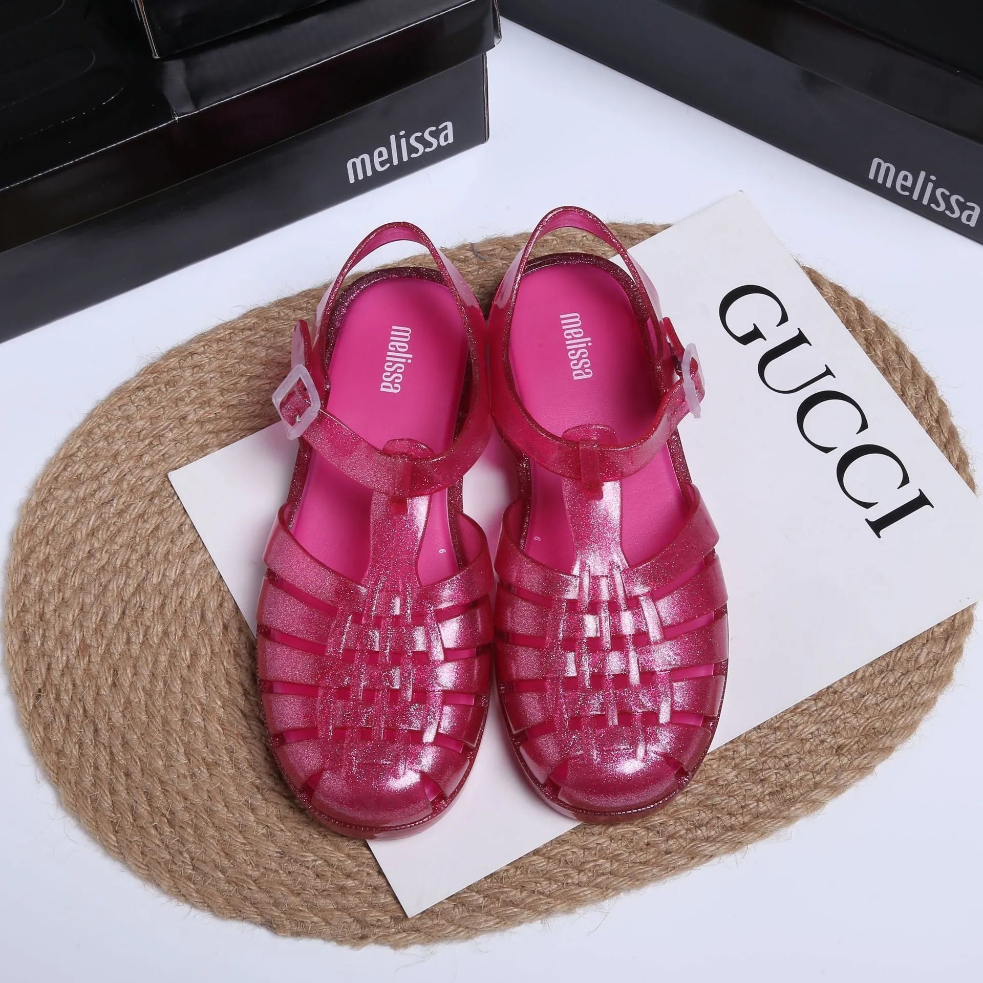 Black Roman-style sandals with buckle fastening and hollow-out design on low-top PVC upper