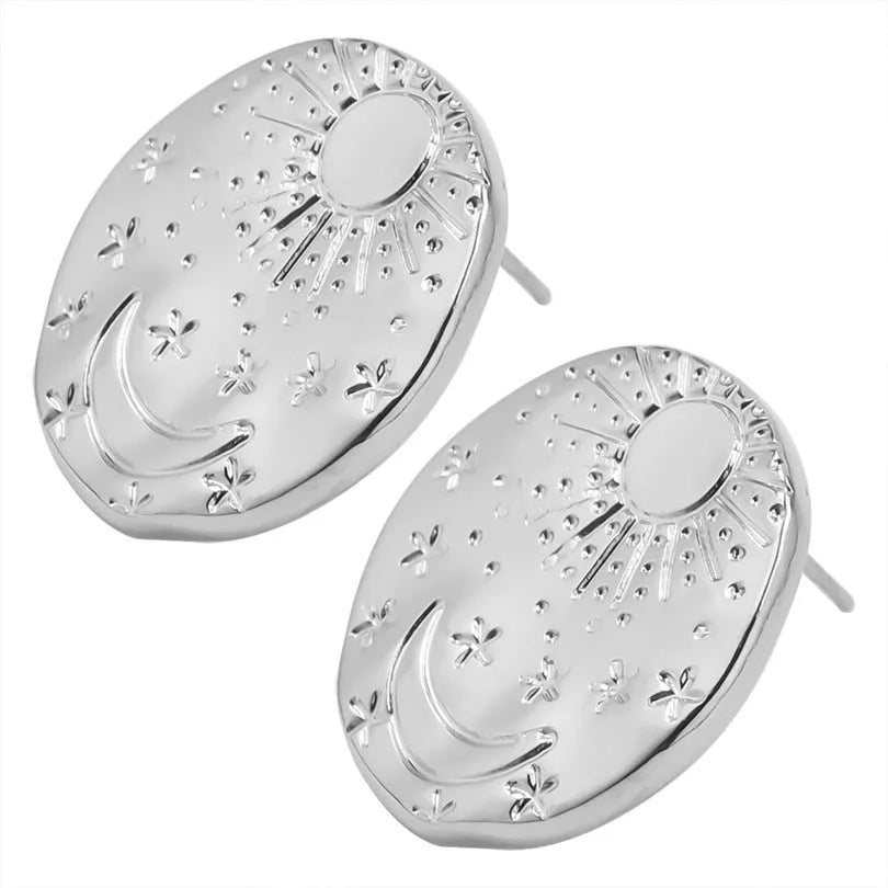 A pair of stainless steel geometric shell stud earrings in a gold electroplated finish on a white background.