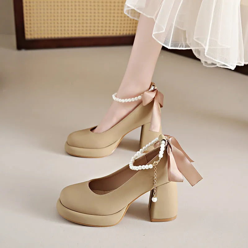 Women's beige Mary Jane shoes with a chunky heel, round toe, and a buckle fastening on the ankle strap.