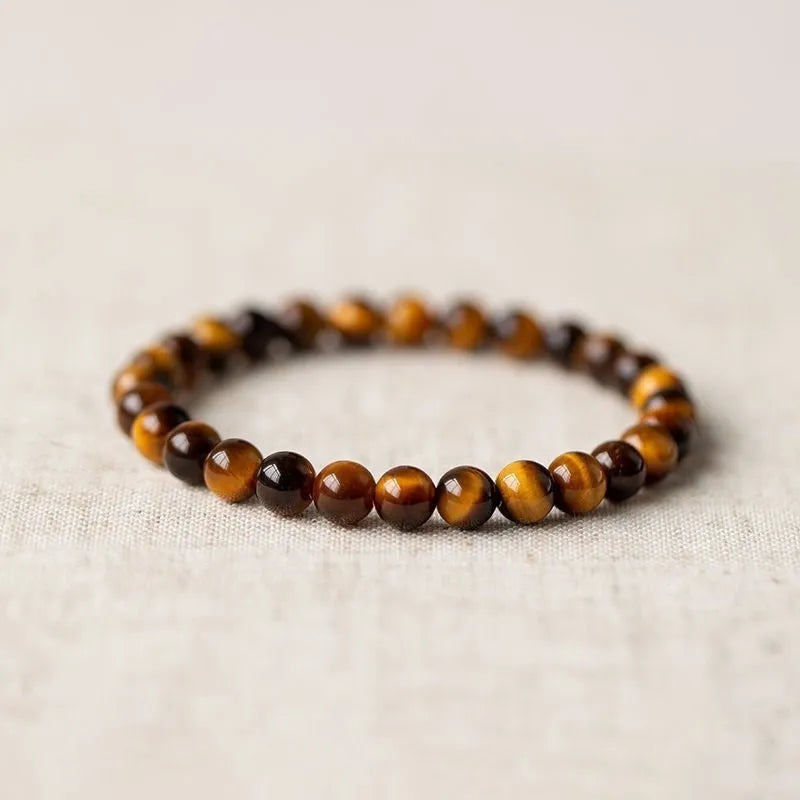 Single Tigereye Dzi bead Buddha rosary bracelet on wrist, showing simple ethnic design.