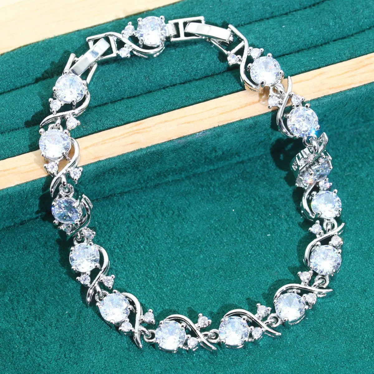 Bridal zircon four-piece jewellery set showing necklace, bracelet, earrings and ring with alloy pendant material