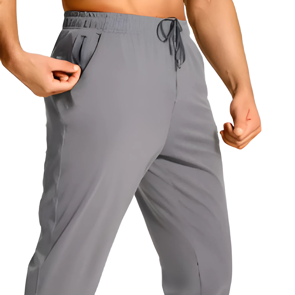 Men's loose-fit solid colour casual trousers made from polyester fabric on a hanger.