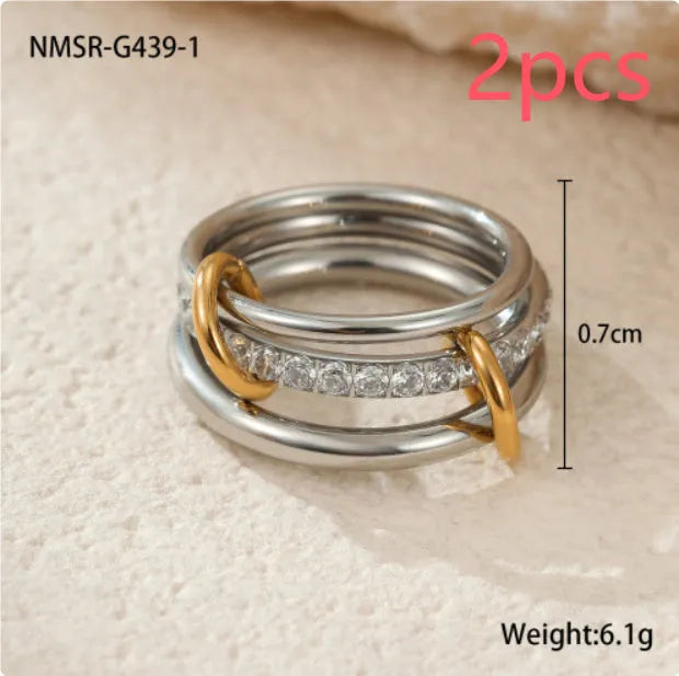 Stacked gold plated stainless steel rings showing layered jewellery look on female hand
