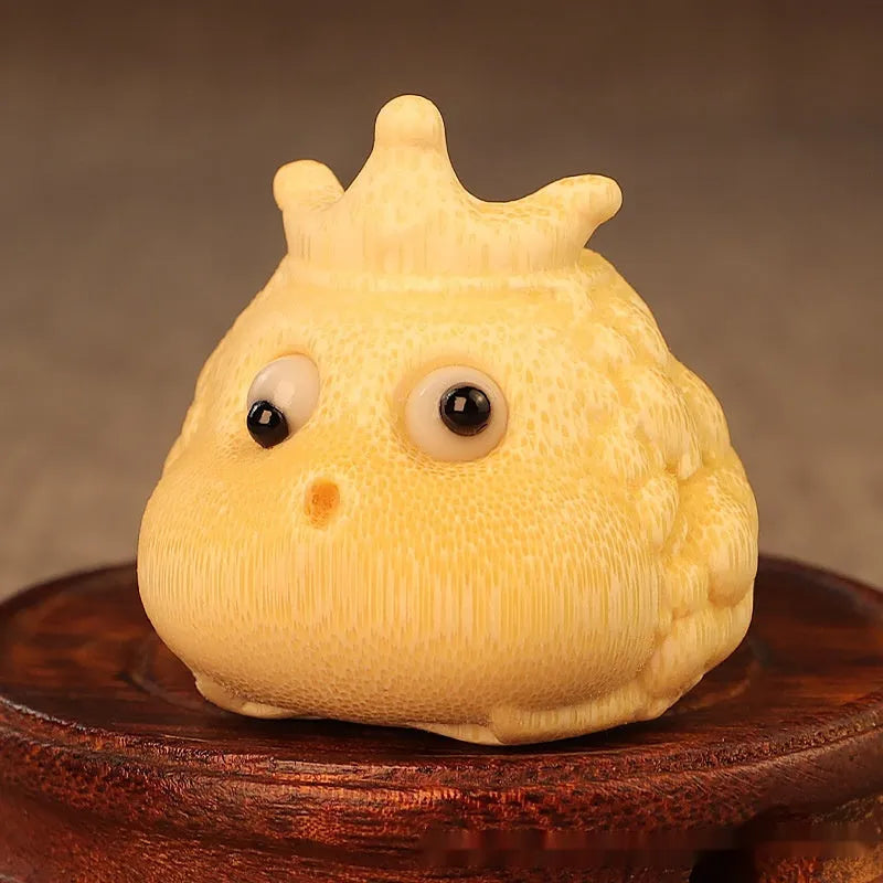Solid bamboo carving of a cute Crown Princess Toad ornament, showing live eye detail.