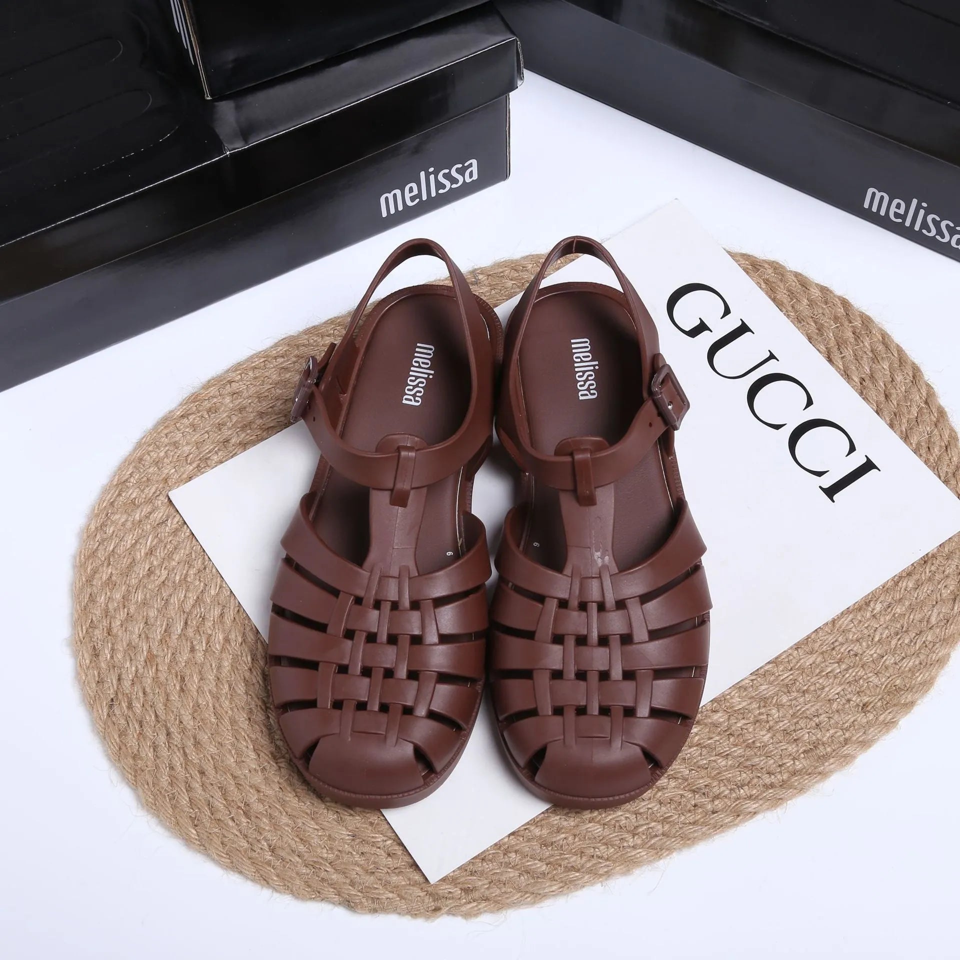 Black Roman-style sandals with buckle fastening and hollow-out design on low-top PVC upper