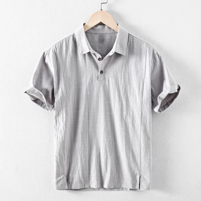 Man wearing a loose-fit light-coloured linen blend casual short-sleeve shirt.