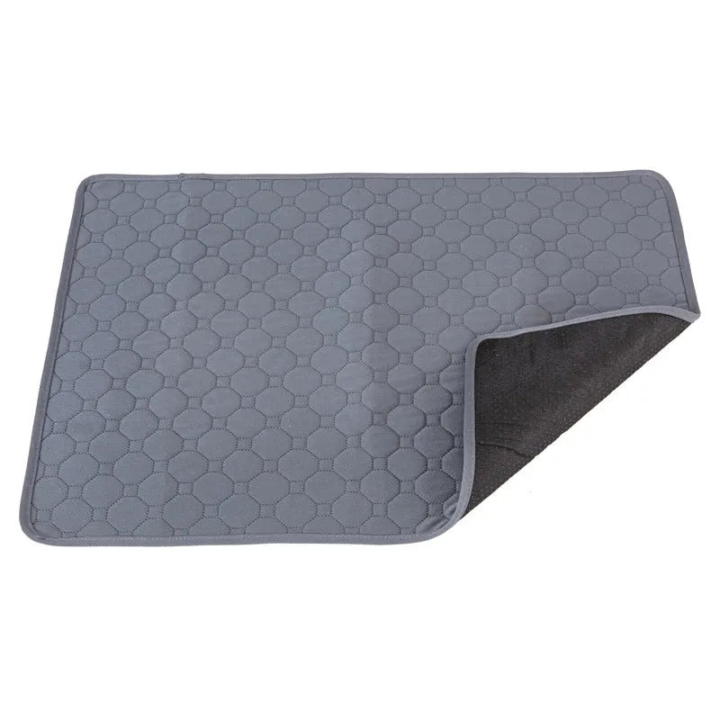 Pack of grey and tan washable, reusable dog pee pads in various sizes on a wooden floor.