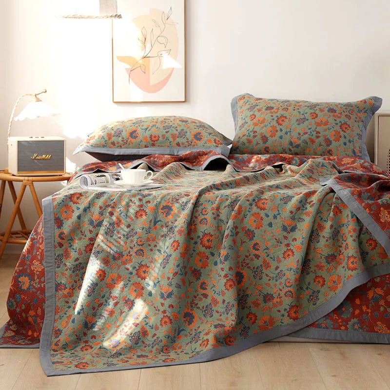 Cotton gauze bed blanket set with floral patterns showing blanket and two pillowcases