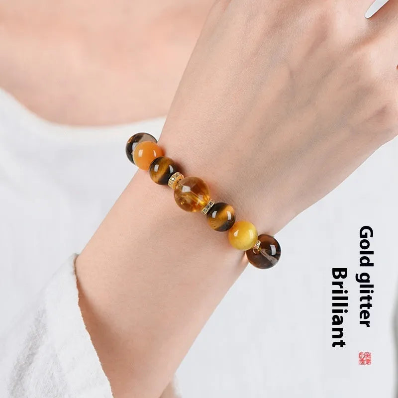 Close-up of a women's bracelet with large 10mm natural yellow artificial crystal beads on a string.