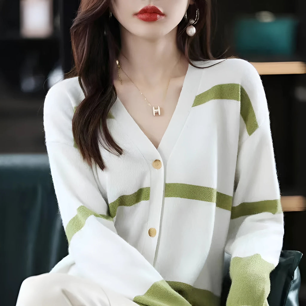 Women's black and white striped V-neck knitted cardigan with 3D pattern on a hanger.