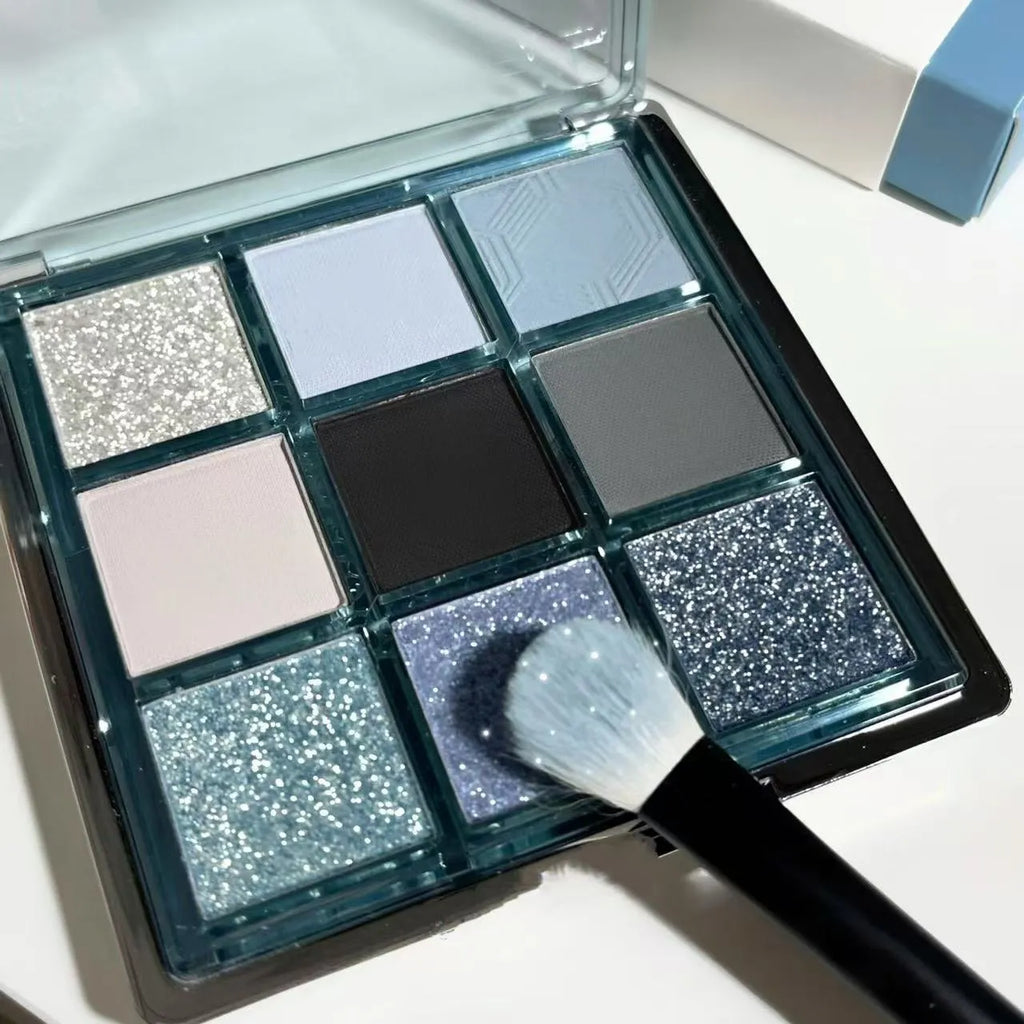 MUGELEEN nine-colour eye shadow palette showing low saturation blue smoked tones with matte and shimmer textures
