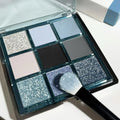 MUGELEEN nine-colour eye shadow palette showing low saturation blue smoked tones with matte and shimmer textures