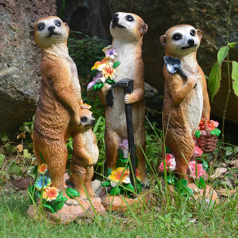 Three resin mongoose garden ornaments with straw hats, including figures holding rake and shovel tools