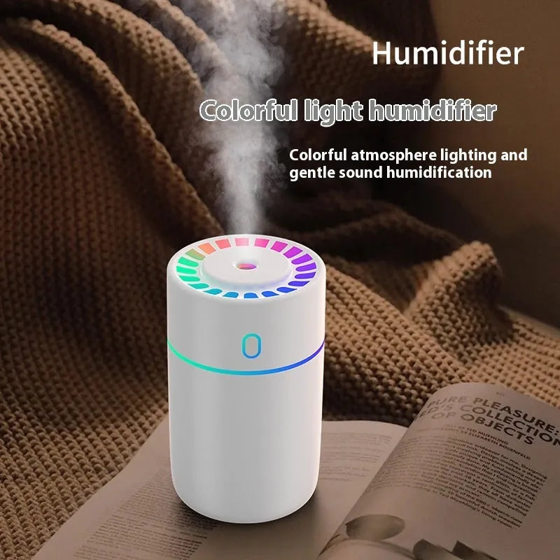 Round plastic USB desktop humidifier in black, pink, and white with single fog outlet