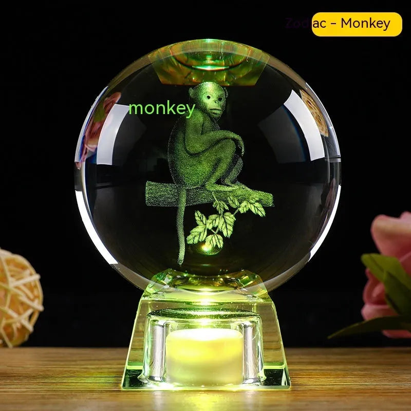 White crystal zodiac decorative ball with electronic base lighting showing Chinese-style animal design