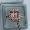 Rose gold geometric alloy ring on a plain background