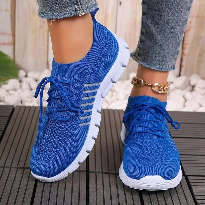 Women's casual breathable flying knit flat shoes in various colours on a white background.