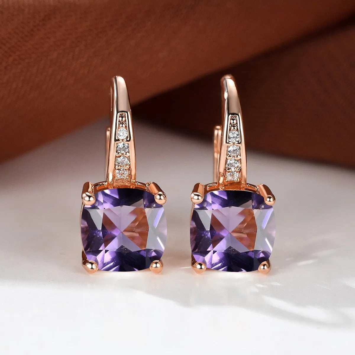 Square geometric ear hook studs with a round zircon stone, shown in a gold electroplated finish.