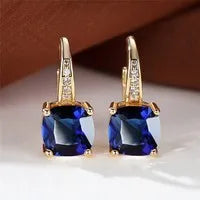 Square geometric ear hook studs with a round zircon stone, shown in a gold electroplated finish.