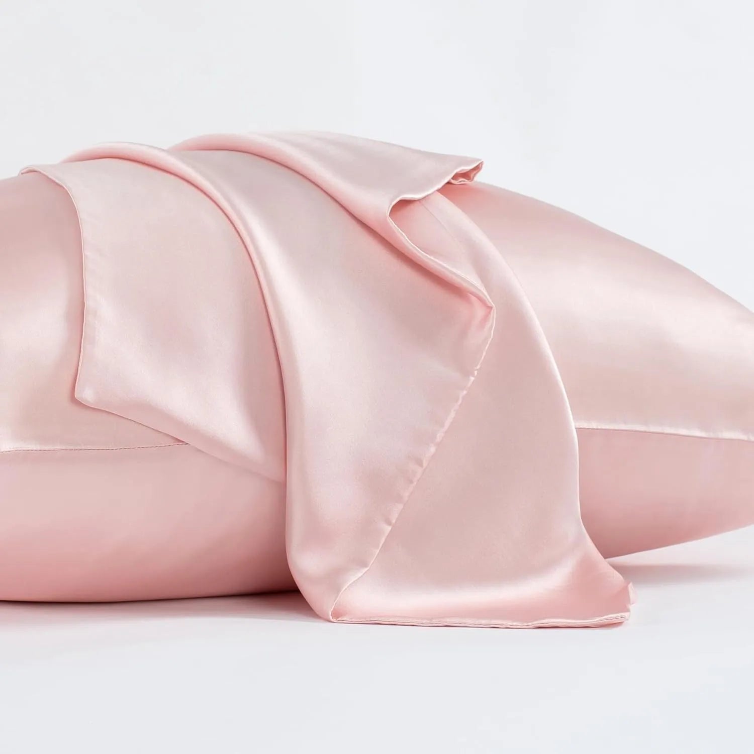 Solid colour mulberry silk envelope pillowcase in dark grey on a bed.