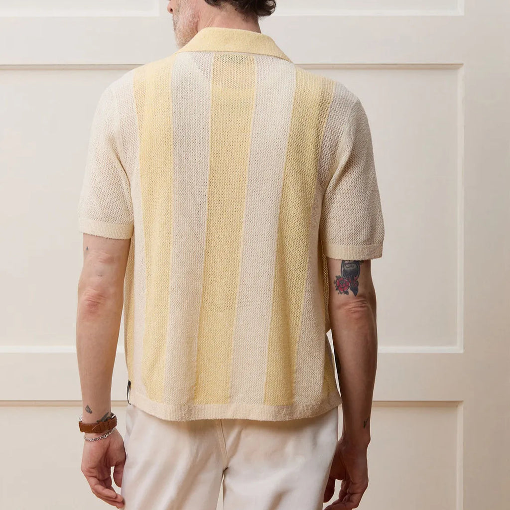 Yellow women's short-sleeved polo shirt with an asymmetric design detail.