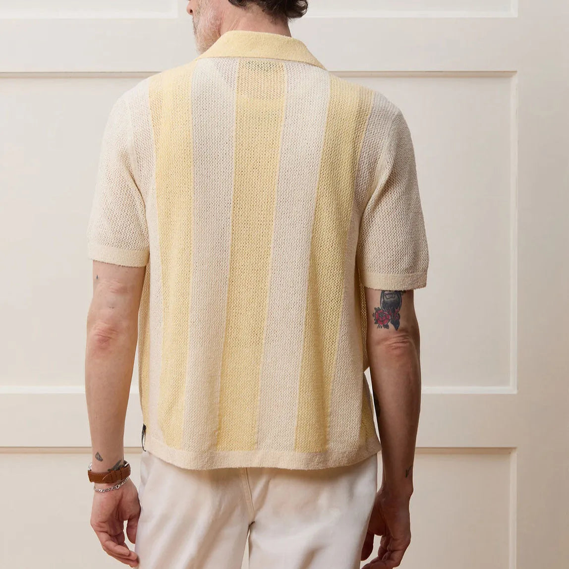 Yellow women's short-sleeved polo shirt with an asymmetric design detail.