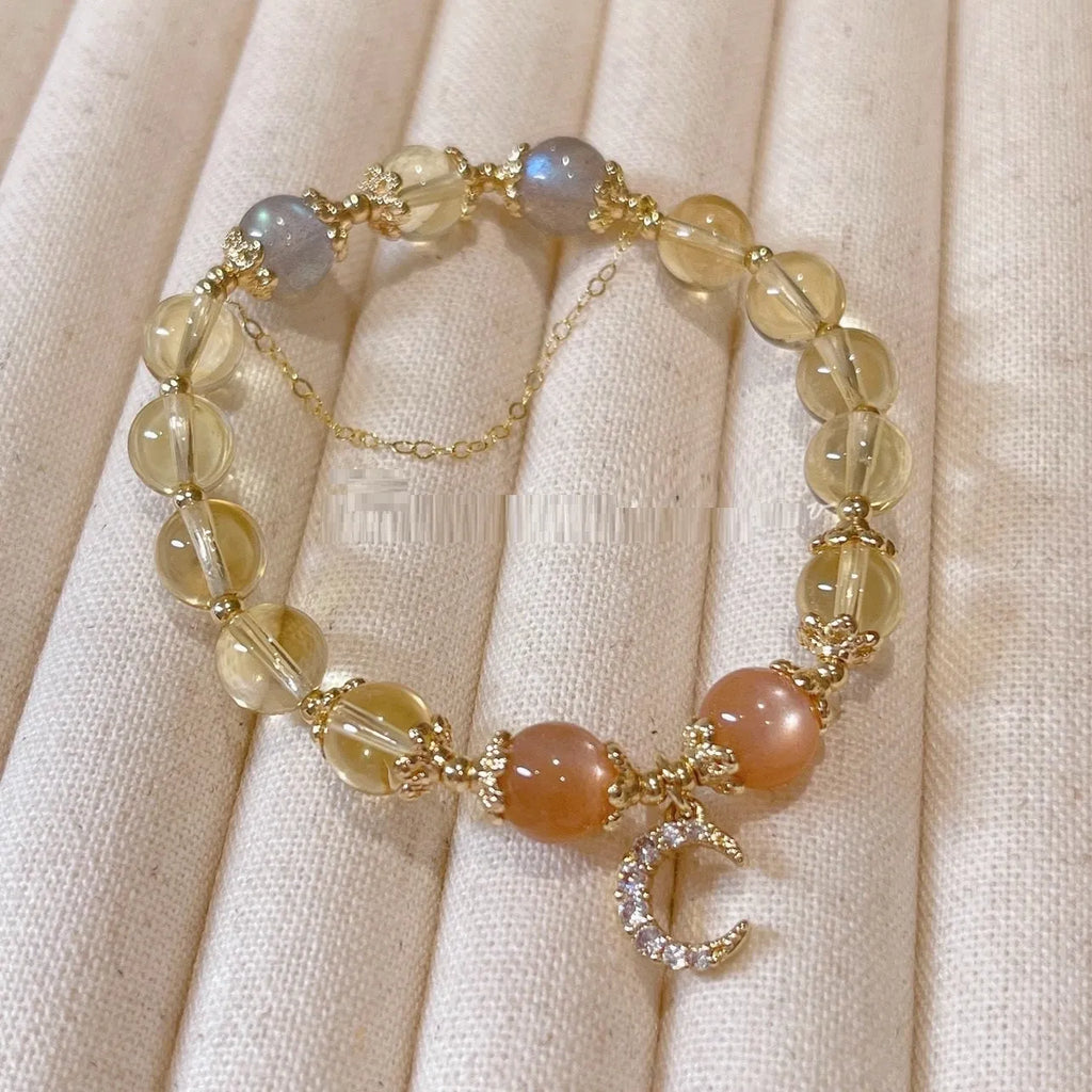Women's crystal bracelet with moonstone and golden sun stone centrepiece, 14K gilded electroplated links, Chinese diamond-shaped style.