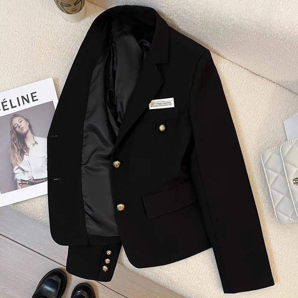 Black women's loose-fit short suit coat with long sleeves and pockets.