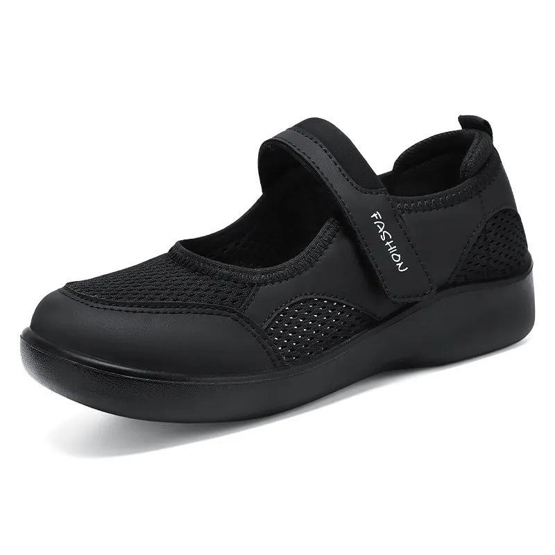 Women's low-top grey mesh sneakers with Velcro straps on a flat polyurethane sole.