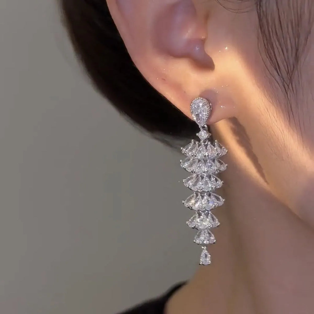 Silver pagoda coloured copper Christmas tree drop earrings with sparkling zircon details and stud fastening.