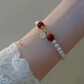 Chinese style glass bracelet with bamboo joint details in a red Lvzhu Duobao design.