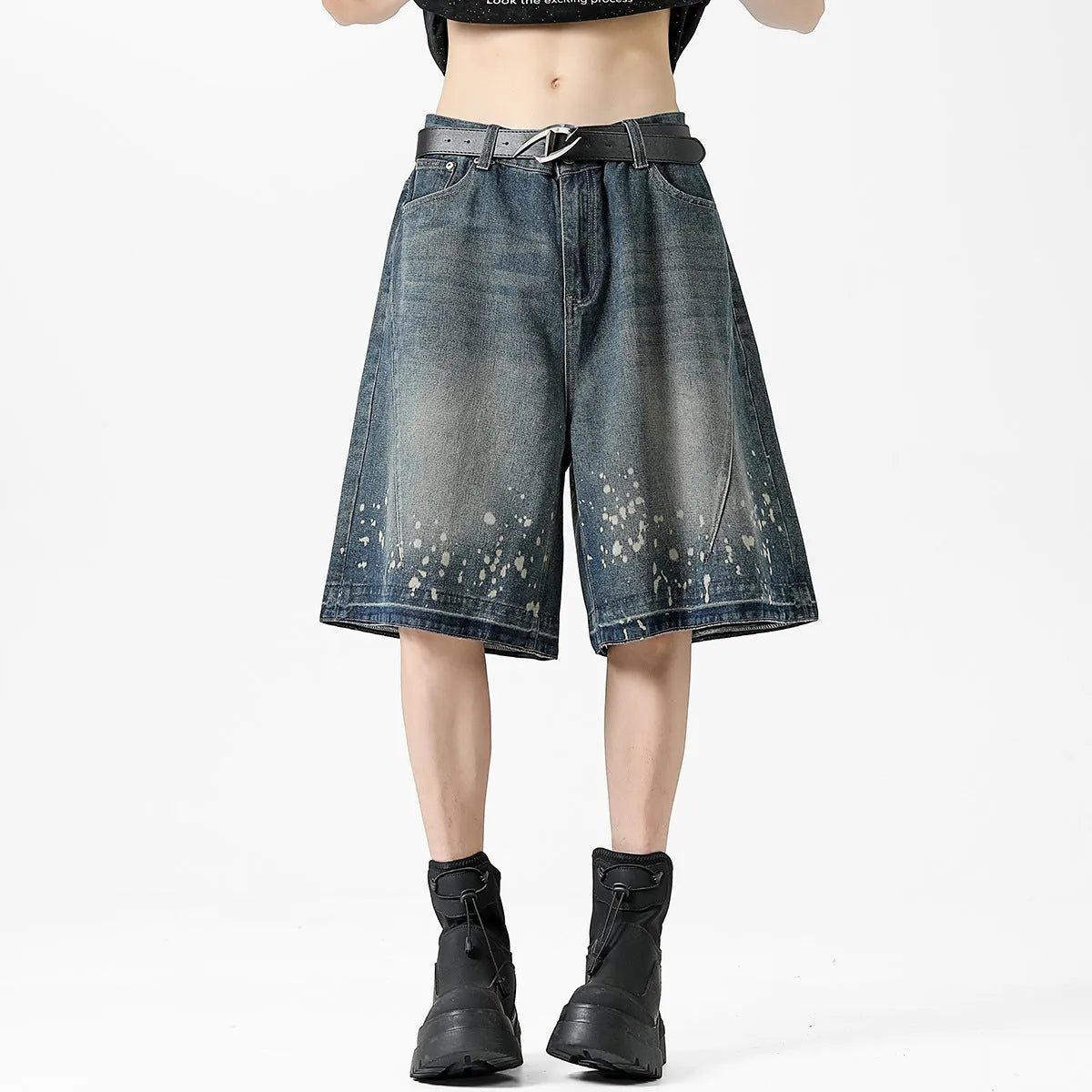 Men's retro blue denim shorts with distressed splash ink design and straight leg cut.