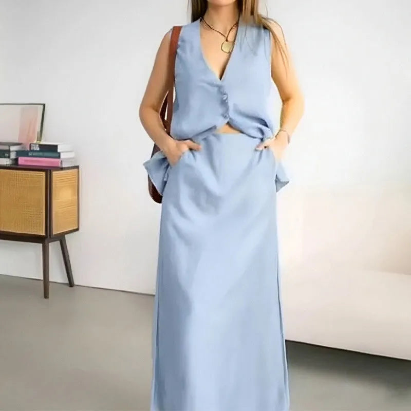 Women's blue loose vest and long skirt two-piece sleeveless suit set on a hanger