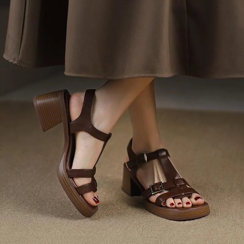 Black retro women's platform sandals with a T-buckle fastening and chunky heel.