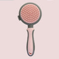 Green and pink reversible cat brush showing slicker brush side and flea comb side with release button