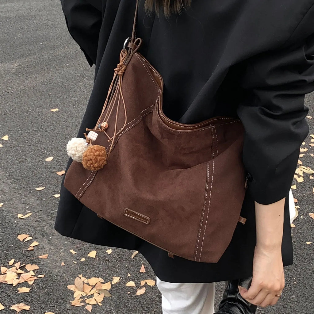 Large capacity soft suede messenger bag in coffee colour with single shoulder strap and sewing line detail