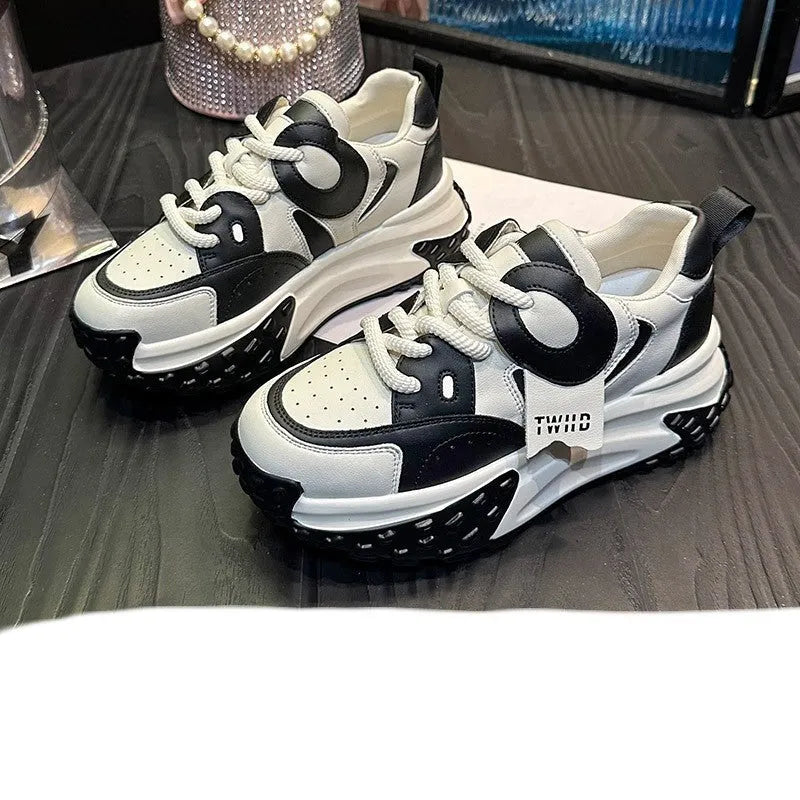 A pair of thick-soled leather casual shoes with a wedge heel and front lace-up design.