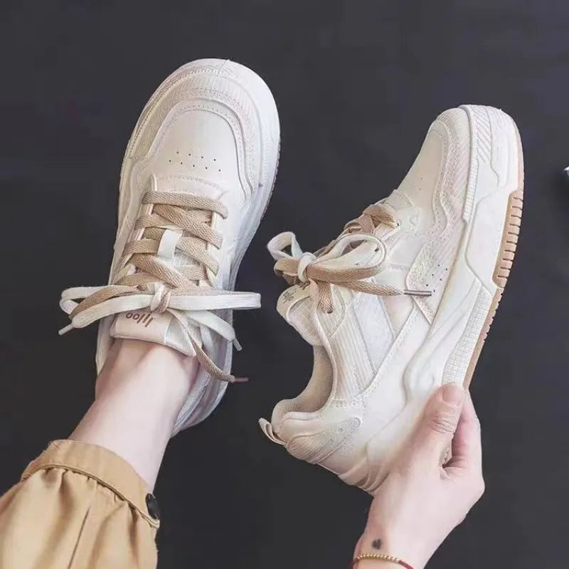 Pink and beige low-top sneakers with rubber soles and height-increasing design