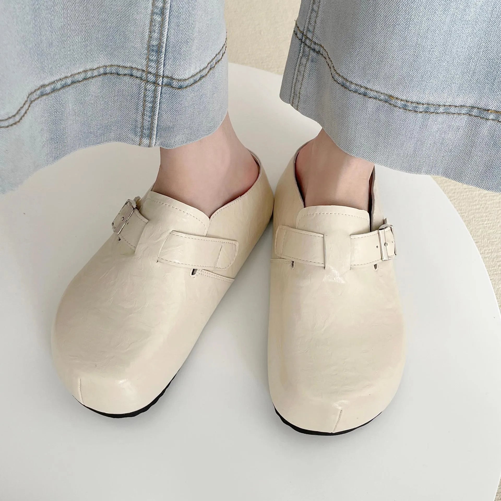 Women's flat buckle casual sneakers in yellow, creamy-white, silver, and black colours with round toe design
