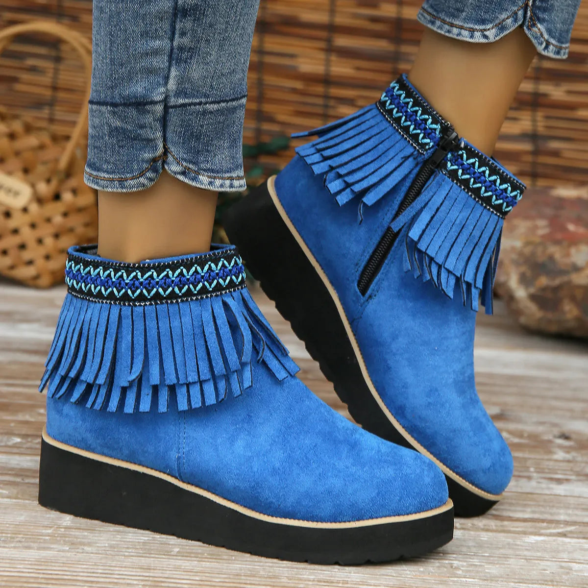 Women's dark brown suede wedge bootie with side zip, tassel detail, and thick rubber sole