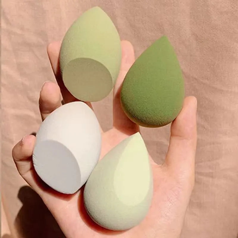 Assorted makeup sponges in seven shapes including pear and peach heart designs, 60x42mm, non-latex material