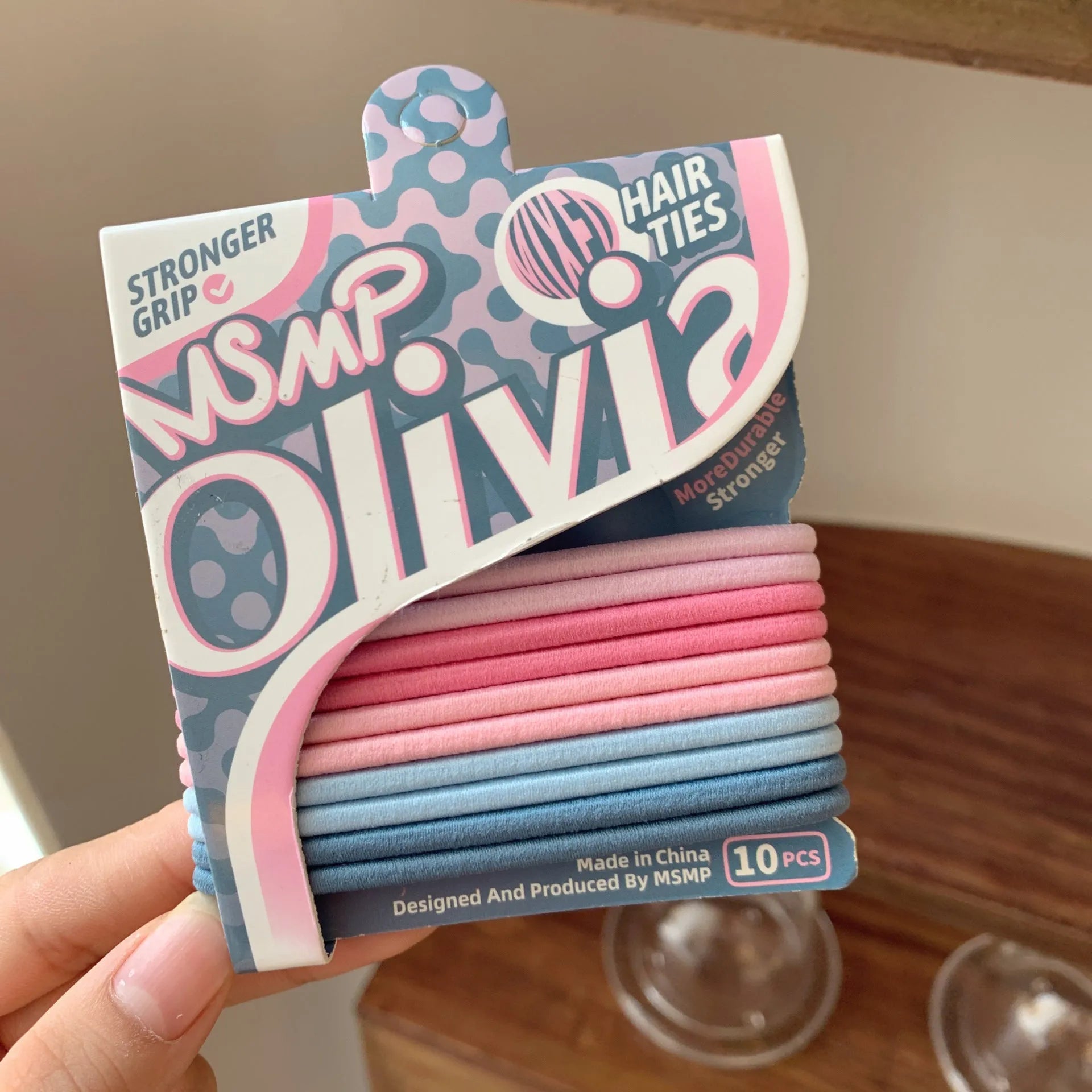 Assortment of candy colour braided elastic hair bands laid flat, showing textured rubber design.