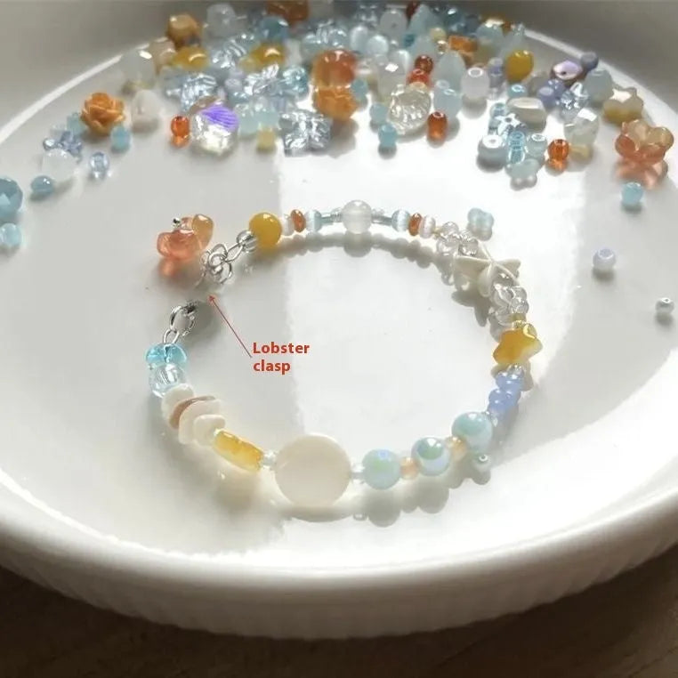 Orange seaside-inspired alloy bracelet with diamond charm and round elements showing water-soaked design aesthetic