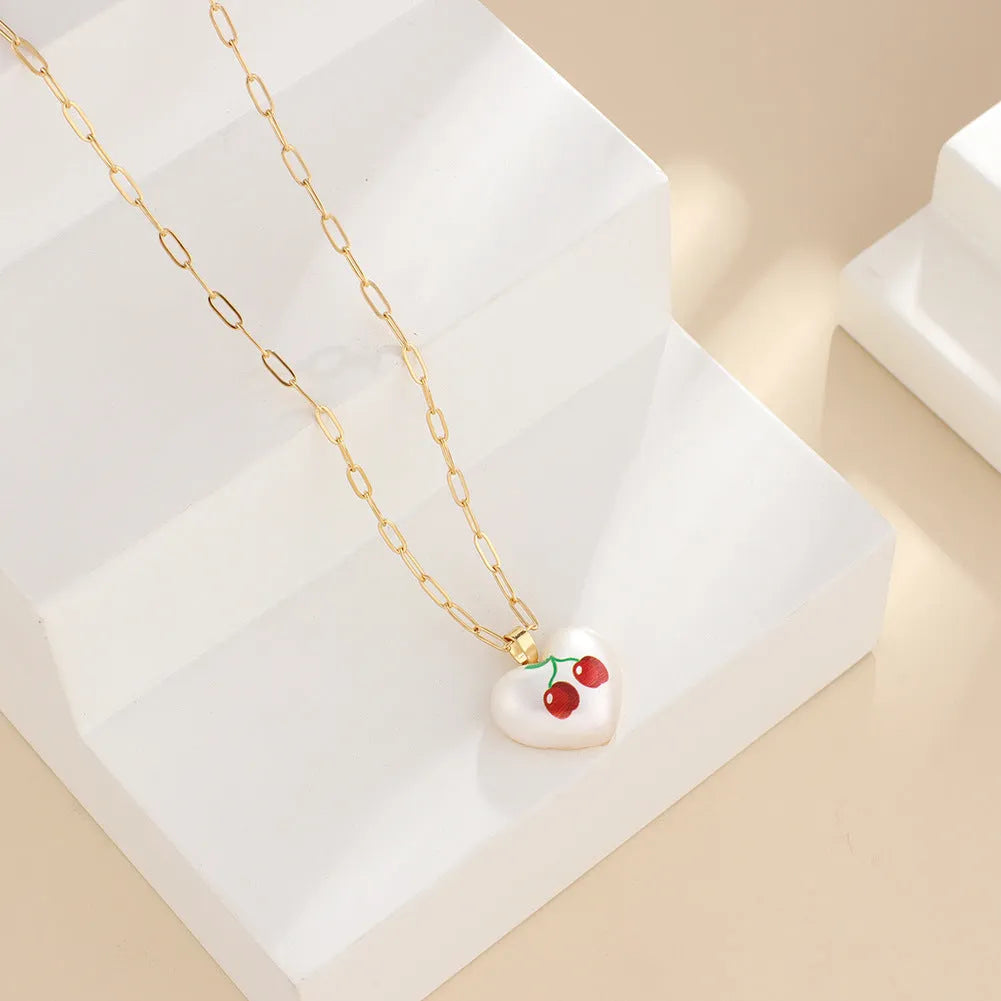 Geometric fruit charm necklace with an adjustable chain, shown in strawberry, pineapple, apple, pear, and cherry colour variants.