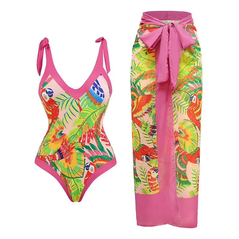 Women's pink floral print one-piece swimsuit with v-neck, covered belly, and attached thin skirt.