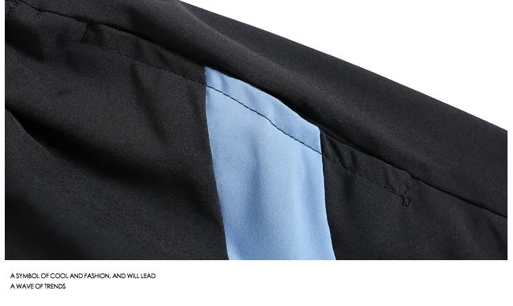 Black and grey loose-fit quick-drying sports shorts with elastic waistband above knee length