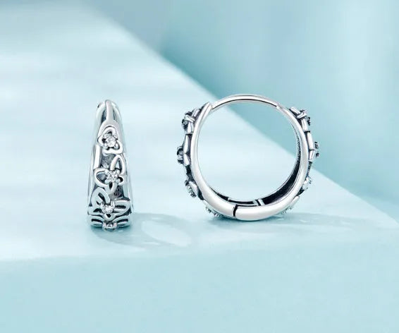 Retro hollow butterfly earrings in oxidised sterling silver with zircon stone accents on a white background.