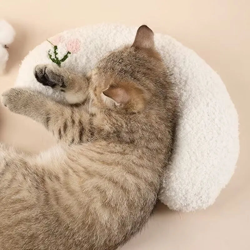Blue U-shaped cat pillow with a question mark design on a white background